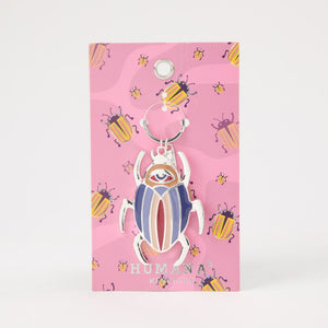 Llavero Beetle Dorado Humana